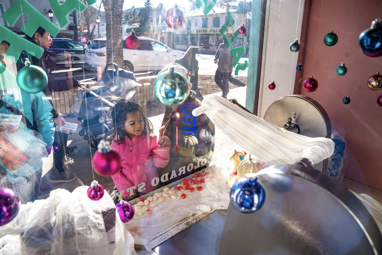 A child looks into an Estes Park candy shop during the holidays